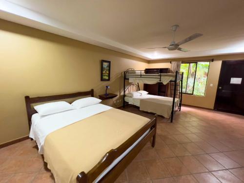 a bedroom with two beds and a bunk bed at Belen Suites in San Antonio