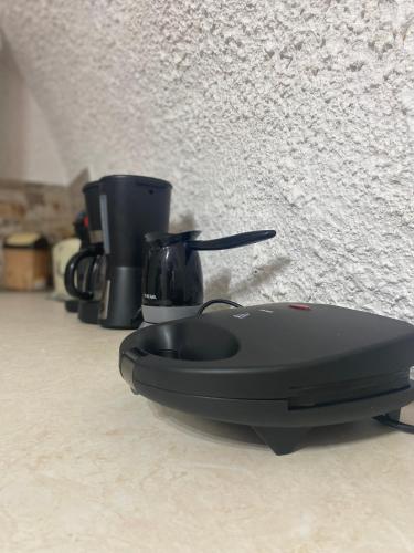 a black appliance sitting on top of a counter at Terra Petra Mani in Koíta