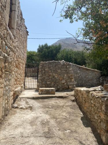 a stone wall with a bench in front of it at Terra Petra Mani in Koíta