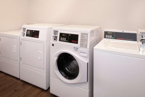 three washing machines and a washer and dryer in a room at Hampton Inn & Suites Buena Park in Buena Park