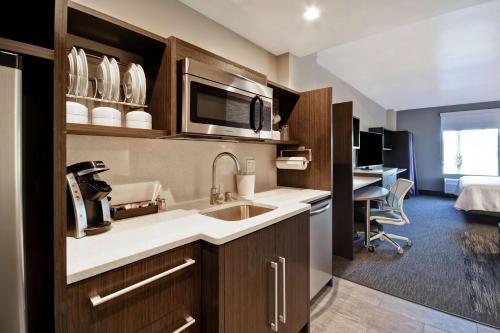 a kitchen with a sink and a desk in a room at Home2 Suites by Hilton Los Angeles Montebello in Montebello