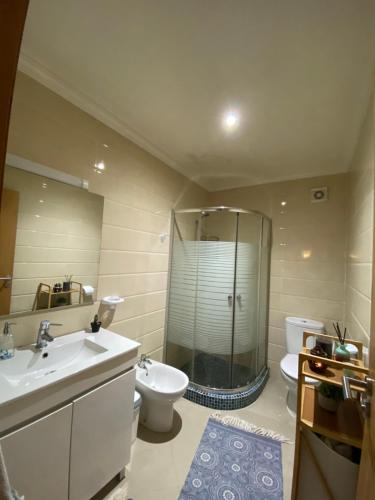 a bathroom with a shower and a toilet and a sink at Asilah marina golf in Asilah