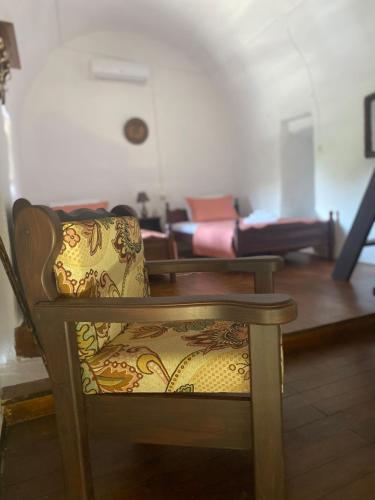 a chair in a living room with a couch at Terra Petra Mani in Koíta
