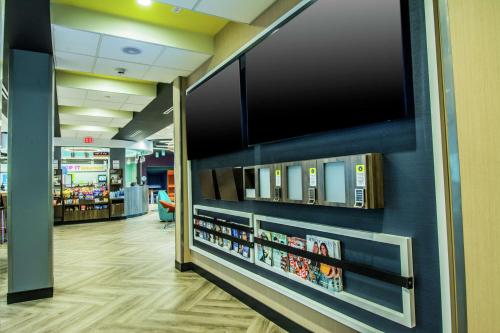 a library with a flat screen tv on a wall at Tru By Hilton Bowling Green in Bowling Green