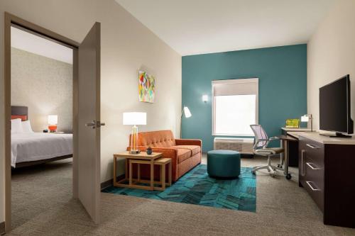 a hotel room with a bed and a couch and a desk at Home2 Suites By Hilton San Antonio North Stone Oak in San Antonio
