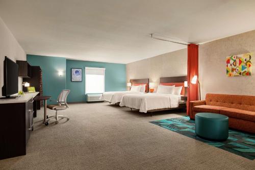 a hotel room with a bed and a couch at Home2 Suites By Hilton San Antonio North Stone Oak in San Antonio