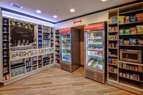 a grocery store aisle with refrigerators and shelves of food at Hampton Inn Discovery Kingdom Napa Gateway in Vallejo