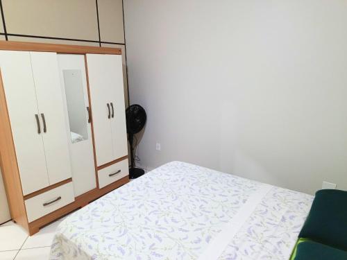 a bedroom with a bed and a dresser and a mirror at Lindo Apto103 em Primavera do Leste in Primavera do Leste
