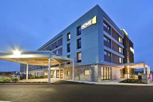 a hotel with a gas station in front of it at Home2 Suites By Hilton Portland Airport in South Portland