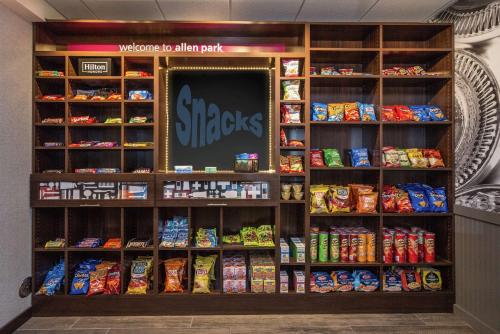 a snack station in a store with snacks on shelves at Hampton Inn & Suites - Allen Park in Allen Park