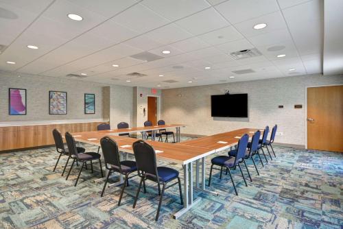 a conference room with a long table and chairs at Home2 Suites By Hilton Portland Airport in South Portland