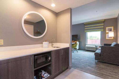 a living room with a sink and a mirror at Hampton Inn & Suites - Allen Park in Allen Park