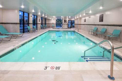 a swimming pool with chairs and chairs in a building at Homewood Suites By Hilton Steamboat Springs in Steamboat Springs