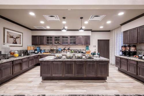 a large kitchen with wooden cabinets and a large island at Homewood Suites By Hilton Steamboat Springs in Steamboat Springs