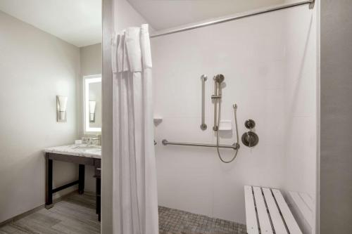 a white bathroom with a shower and a sink at Homewood Suites By Hilton Steamboat Springs in Steamboat Springs