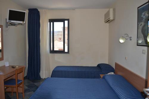 Ένα ή περισσότερα κρεβάτια σε δωμάτιο στο Hotel Jonic