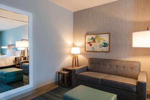 a hotel room with a couch and a bedroom at Home2 Suites By Hilton Nashville Bellevue in Bellevue