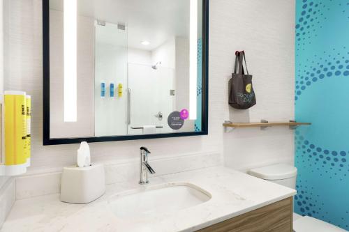 a bathroom with a sink and a toilet and a mirror at Tru By Hilton Florence I-95 in Florence
