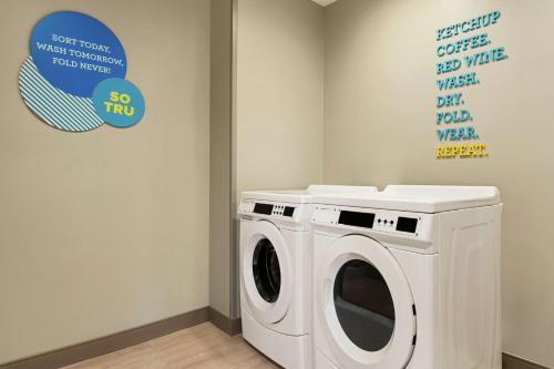 a washing machine in a room with a sign at Tru By Hilton Florence I-95 in Florence