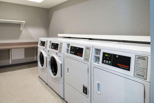a laundry room with three washers and a dryer at Hampton Inn Tampa Downtown Channel District in Tampa