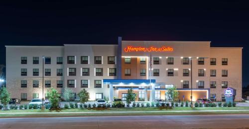 a hotel with a sign on the front of it at Hampton Inn & Suites Dallas East in Dallas