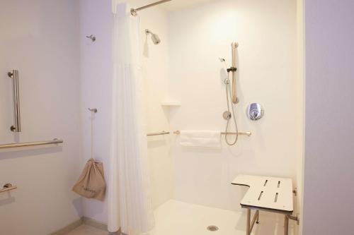 a white bathroom with a shower and a sink at Hilton Garden Inn Elizabethtown in Elizabethtown