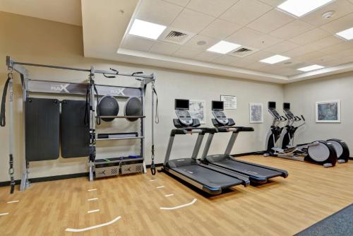 a gym with two treadmills and weights in a room at Hilton Garden Inn Princeton Lawrenceville in Lawrenceville