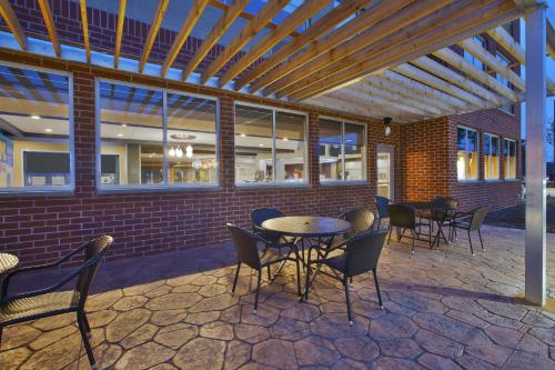 a patio with tables and chairs in front of a building at Tru By Hilton Jackson in Jackson
