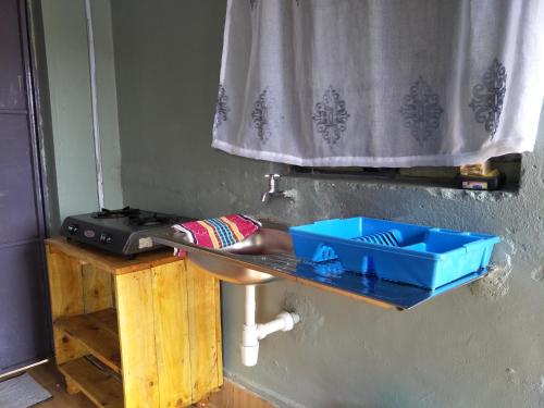 a bathroom sink with a blue box on top of it at Wrech House Sagana -1989 in Sagana