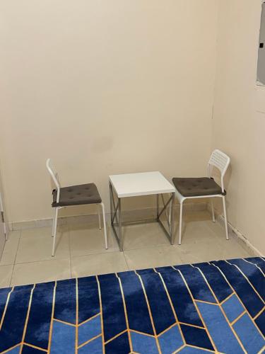two chairs and a table in a room at Fateh Building in Dubai