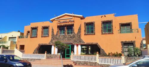 a building in the middle of a parking lot at Castillo Mar 95 in Caleta De Fuste