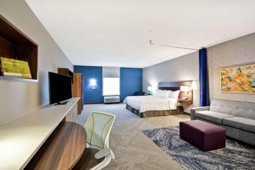 una camera d'albergo con letto e divano di Home2 Suites Plano Legacy West a Plano