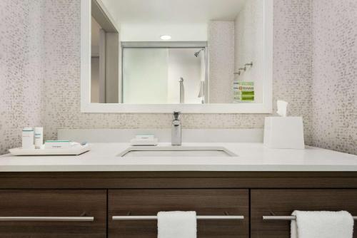 a bathroom with a sink and a mirror at Home2 Suites By Hilton Brooklyn Park Minneapolis in Brooklyn Park
