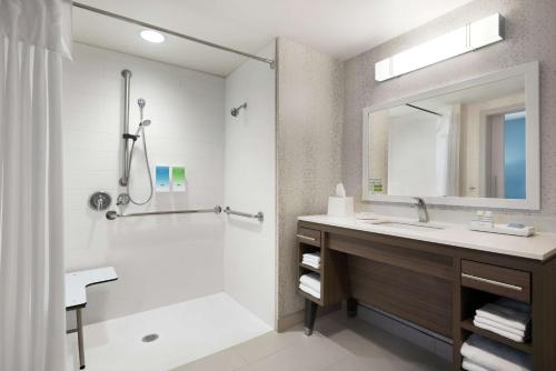 a bathroom with a sink and a shower at Home2 Suites By Hilton Brooklyn Park Minneapolis in Brooklyn Park
