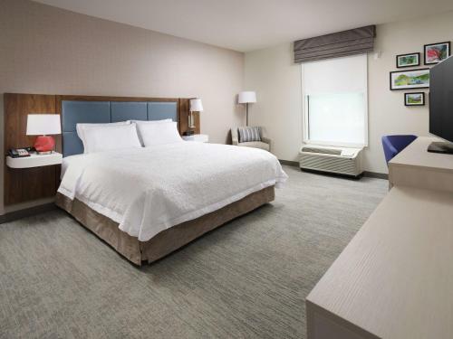 a hotel room with a large bed and a window at Hampton Inn Chattanooga East Ridge in Chattanooga