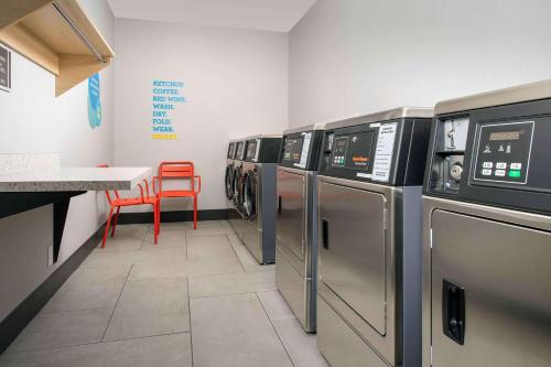a laundry room with a row of washers and dryers at Tru By Hilton Nashville Downtown Convention Center in Nashville