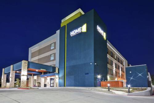 a hotel with a sign on the side of a building at Home2 Suites By Hilton Bedford Dfw West in Bedford