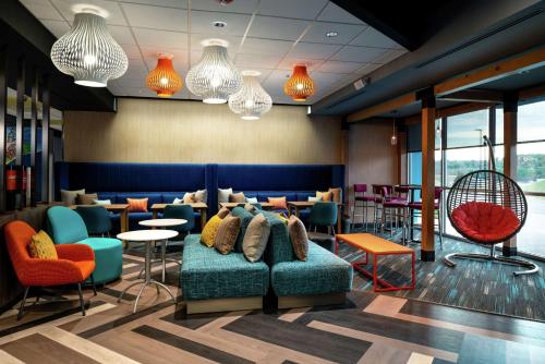 a lobby with a couch and chairs and tables at Tru By Hilton Staunton in Staunton