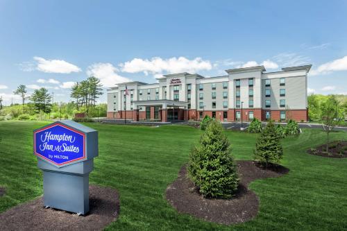 a hotel with a sign in front of a building at Hampton Inn & Suites Kittery-Portsmouth in Kittery