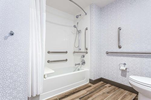 a bathroom with a bath tub and a toilet at Hampton Inn & Suites Kittery in Kittery
