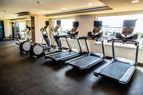 a gym with several tread machines in a room at Hampton Inn & Suites By Hilton Puebla in Puebla