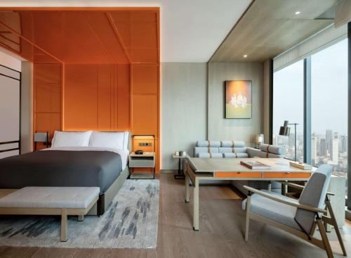 a bedroom with a bed and a desk and a couch at Canopy by Hilton Chengdu City Centre in Chengdu