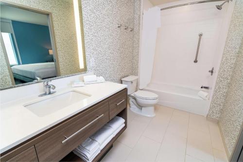 a bathroom with a sink and a toilet and a mirror at Home2 Suites By Hilton San Antonio At The Rim, Tx in San Antonio