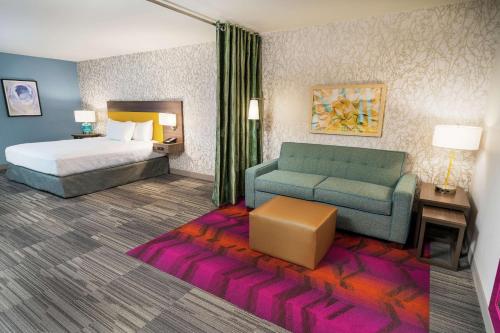 a rendering of a hotel room with a bed and a couch at Home2 Suites By Hilton San Antonio At The Rim, Tx in San Antonio