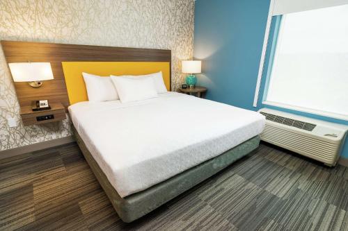 a bedroom with a bed and a large window at Home2 Suites By Hilton San Antonio At The Rim, Tx in San Antonio
