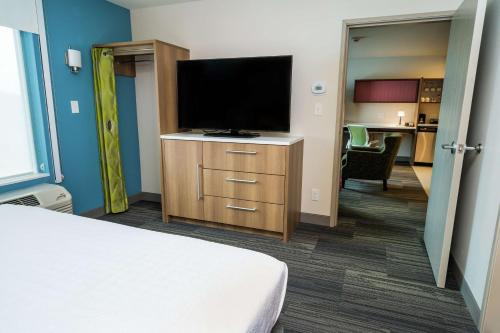 a hotel room with a bed and a flat screen tv at Home2 Suites By Hilton San Antonio At The Rim, Tx in San Antonio