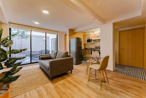 a living room with a couch and a table at Condesa Cholula Lofts by VH in Mexico City