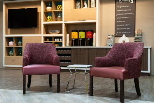 two purple chairs and a table in a store at Home2 Suites By Hilton Charlotte Mooresville, Nc in Mooresville