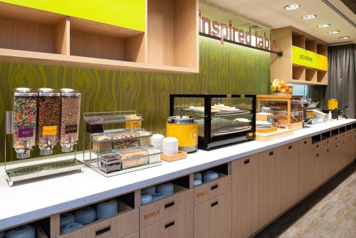 a bakery with a counter with food on it at Home2 Suites By Hilton Charlotte Mooresville, Nc in Mooresville
