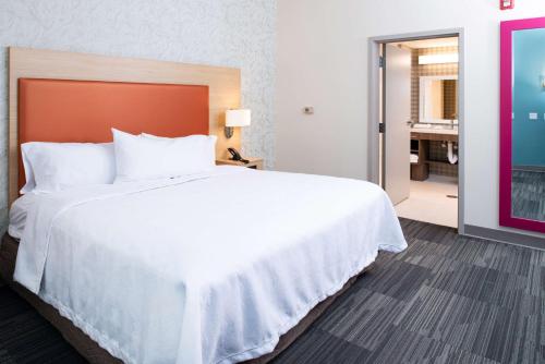 a large white bed in a hotel room at Home2 Suites By Hilton Charlotte Mooresville, Nc in Mooresville